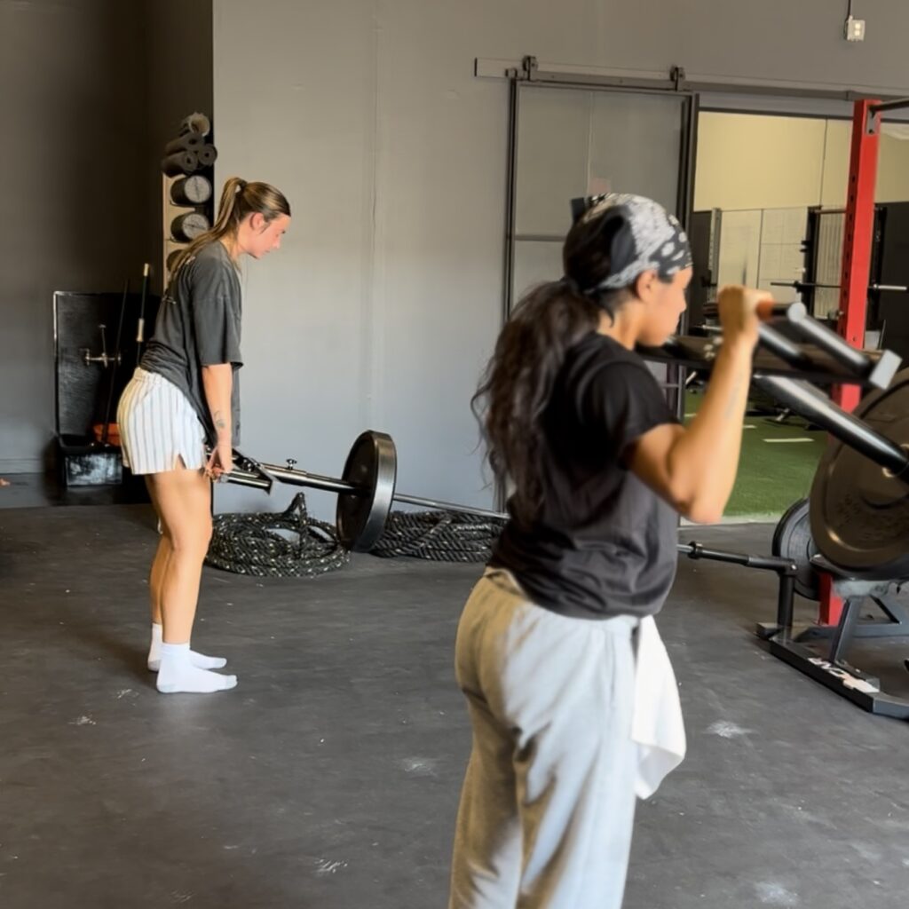 Women lifting weights, RDL