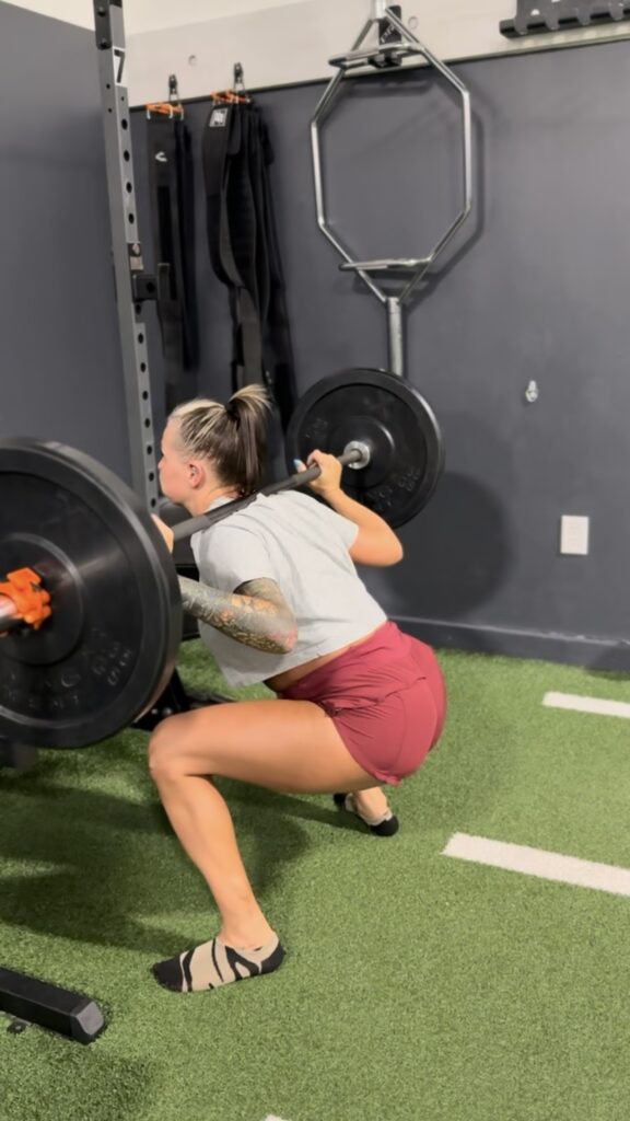 Woman squatting, glute growth, prosper texas, strength training